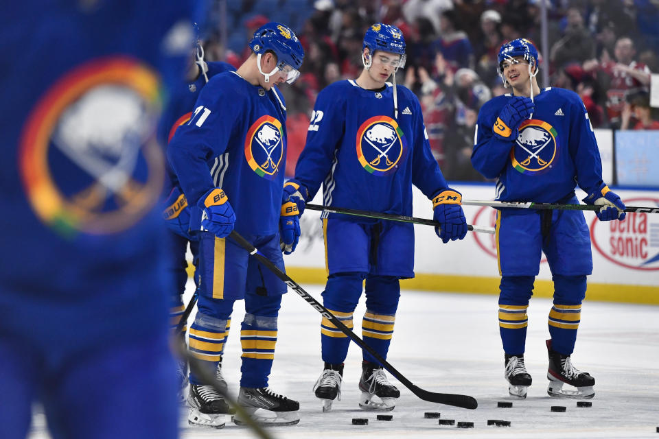 Buffalo Sabres left wing Victor Olofsson, left, right wing Jack Quinn and right wing JJ Peterka wear special warmup jerseys commemorating Pride Night before an NHL hockey game against the Montreal Canadiens in Buffalo, N.Y., Monday, March 27, 2023. (AP Photo/Adrian Kraus)