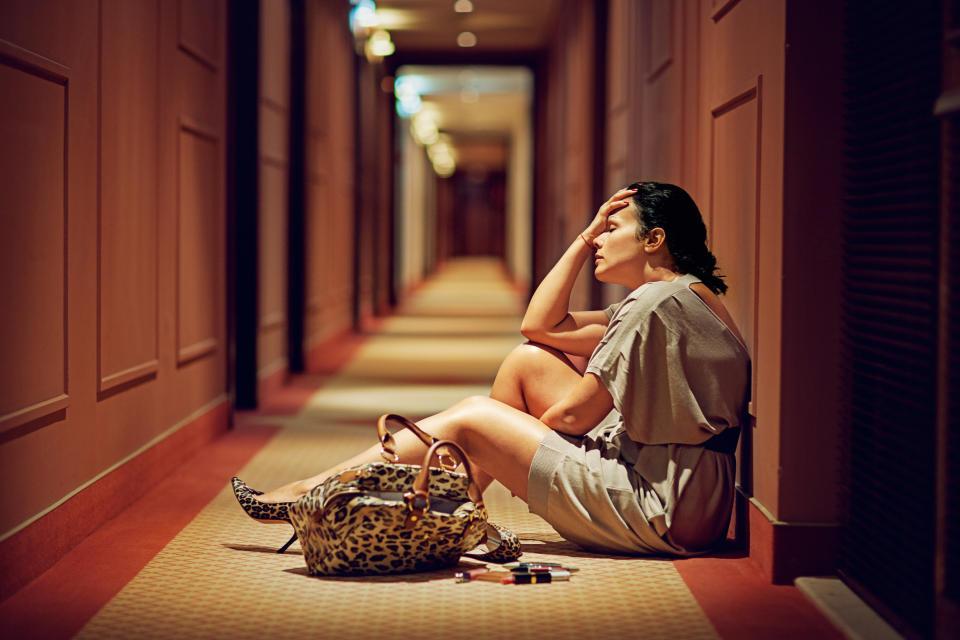 woman sitting in a hotel hallway