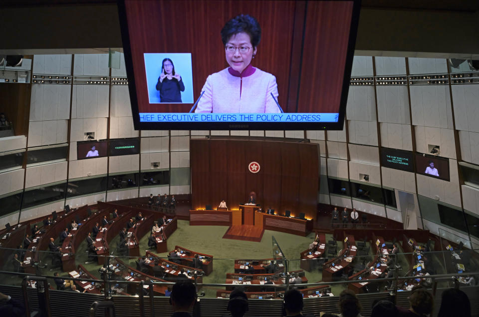 A video screen shows Hong Kong Chief Executive Carrie Lam delivering her policy speech at the Legislative Council in Hong Kong Wednesday, Oct. 10, 2018. Lam has unveiled a major reclamation project called "Lantau Tomorrow Vision," under which about 1,700 hectares will be developed to provide homes for 1.1 million people, according to government radio. (AP Photo/Vincent Yu)