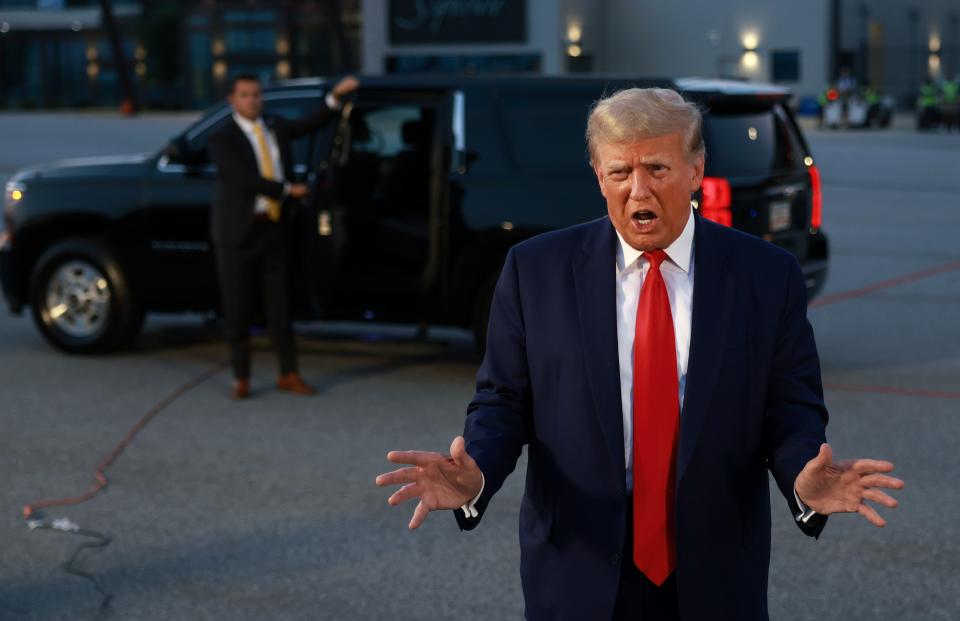 Former President Donald Trump speaks to the media at Atlanta Hartsfield-Jackson International Airport after surrendering at the Fulton County jail.