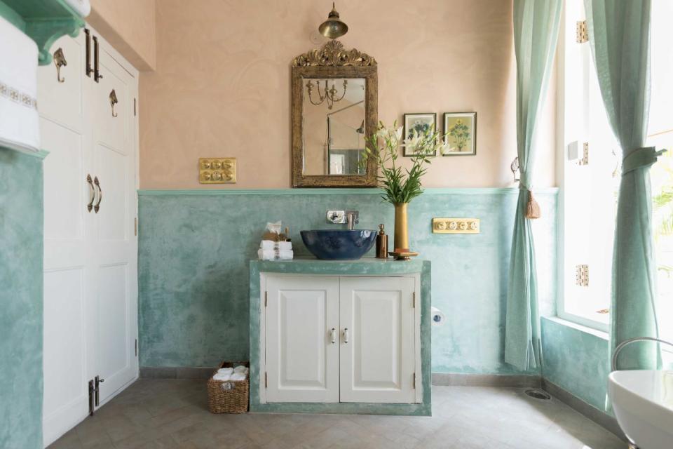 The ensuite bathroom is bathed in soothing blues.