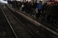 Commuters walk out of a train at the Gare Saint Lazare station in Paris, France, Monday, Dec. 16, 2019. French transport strikes against a planned overhaul of the pension system entered their twelfth day Monday as French president Emmanuel Macron's government remains determined to push ahead with its plans. (AP Photo/Francois Mori)