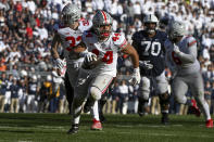 Ohio State defensive end J.T. Tuimoloau (44) returns an interception for a touchdown during the fourth quarter of an NCAA college football game against Penn State, Saturday, Oct. 29, 2022, in State College, Pa. Ohio State won 44-31. (AP Photo/Barry Reeger)