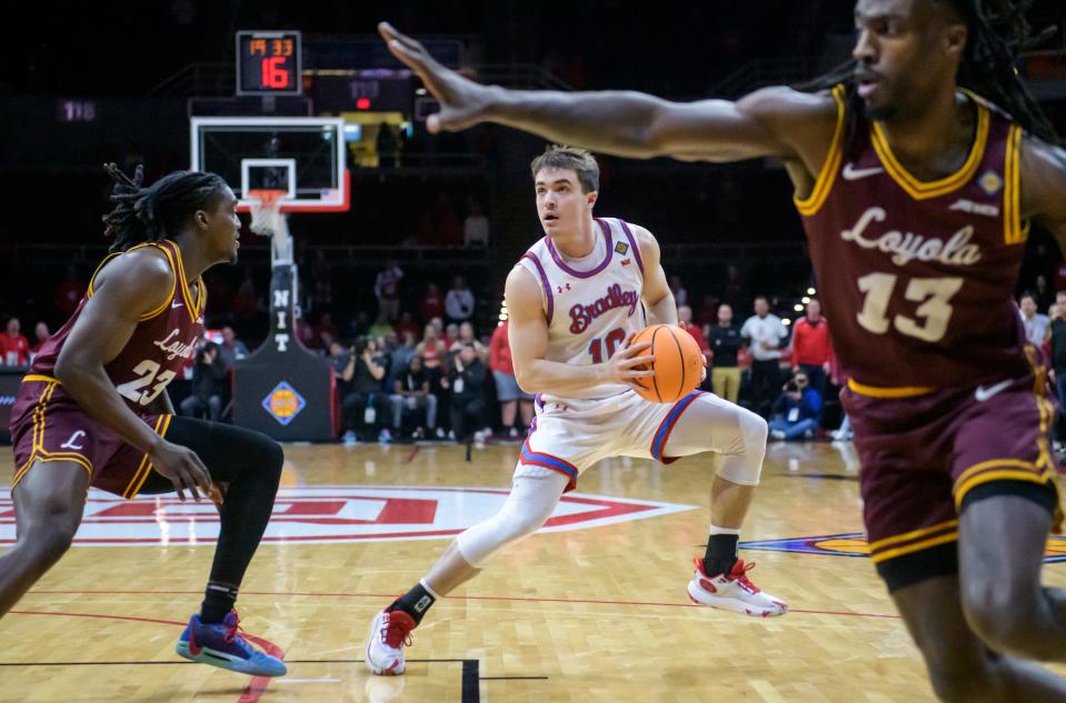 Bradley's Connor Hickman (10) eyes the basket as he maneuvers through the Loyola Chicago defense in the first half of their first-round NIT basketball game Wednesday, March 20, 2024 at Carver Arena.