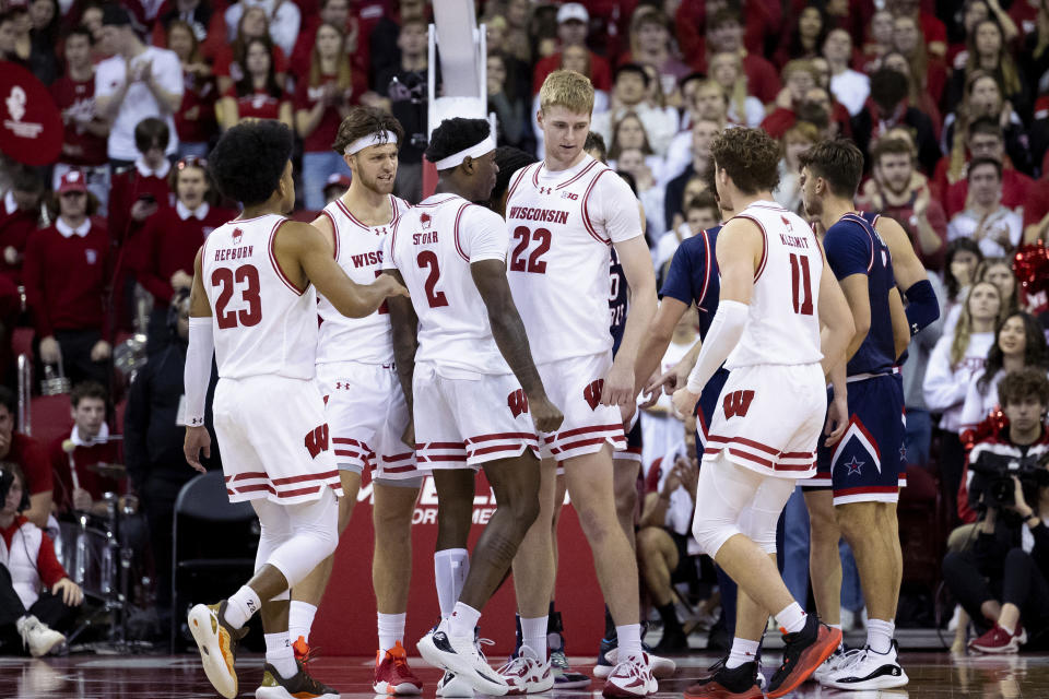 Wisconsin forward Steven Crowl (22) reacts with his teammates during the first half of an NCAA college basketball game against Robert Morris in Madison, Wis., Friday, Nov. 17, 2023. (Samantha Madar/Wisconsin State Journal via AP)