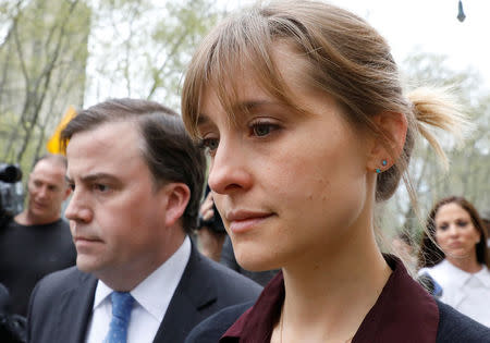 Actor Allison Mack, known for her role in the TV series 'Smallville', exits with her lawyer following a hearing on charges of sex trafficking in relation to the Albany-based organization Nxivm at United States Federal Courthouse in Brooklyn, New York, U.S., May 4, 2018. REUTERS/Brendan McDermid