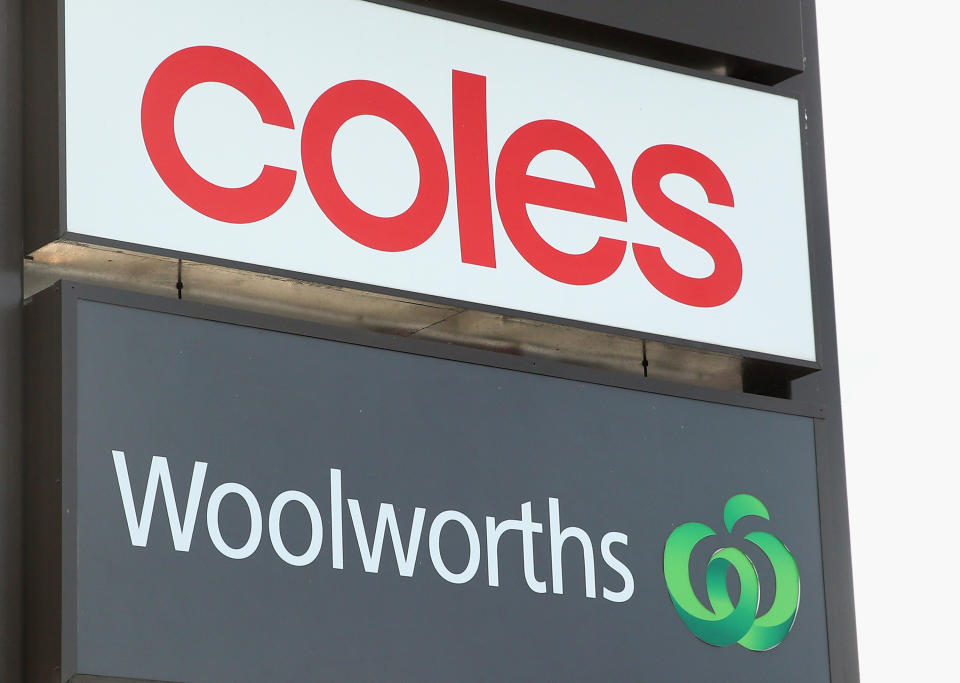 A Coles and Woolworths sign.