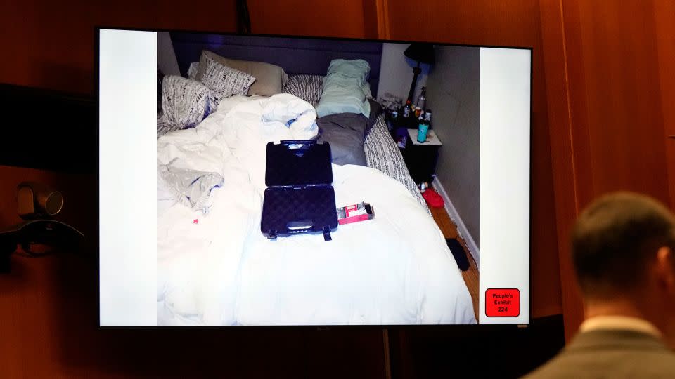 In a screengrab from video, tan empty gun case and ammunition box are seen on the bed of James and Jennifer Crumbley during his trial on Tuesday. - Carlos Osorio/Pool/AP