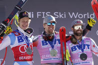 Norway's Aleksander Aamodt Kilde, center, celebrates a first place finish while posing beside second-place finisher Switzerland's Marco Odermatt, left, and third-place finisher United States' Travis Ganong after a men's World Cup super-G skiing race Friday, Dec. 3, 2021, in Beaver Creek, Colo. (AP Photo/Gregory Bull)