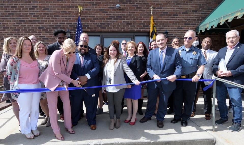 Martha Danner, director of Maryland's Division of Parole and Probation, joins Secretary Robert Green of the Maryland Department of Public Safety and Correctional Services, department employees and others as they cut the ribbon for the new Parole and Probation Hagerstown Field Office on April 22.