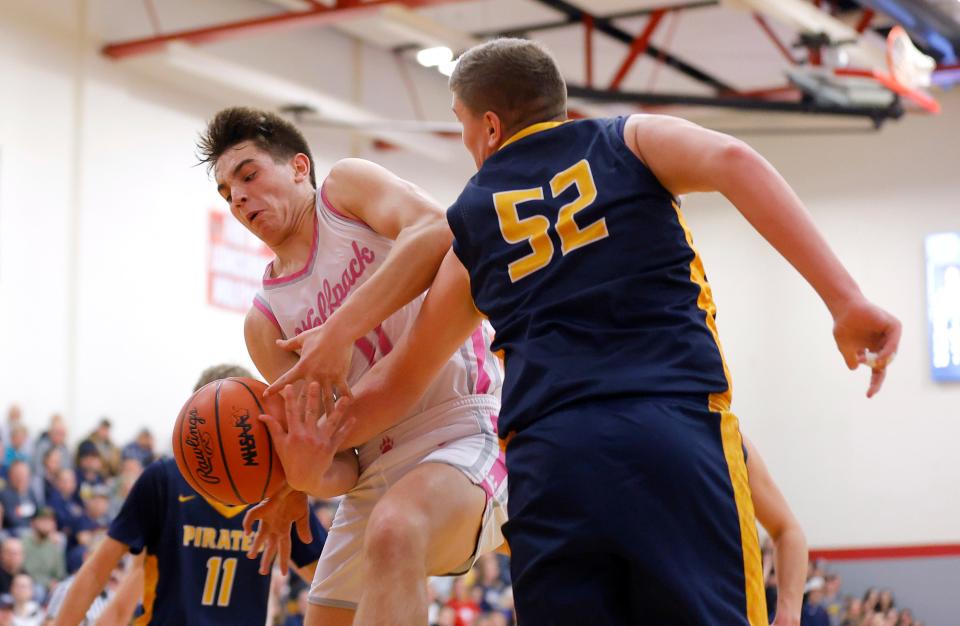 Laingsburg's Jackson Audretsch, left, and Pewamo-Westphalia's Trent Piggott (52) vie for a rebound, Tuesday, Jan. 23, 2024, in Laingsburg.