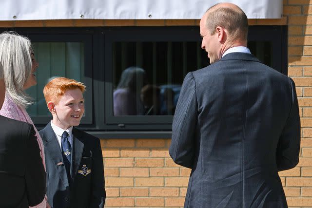 <p>Zak Hussein / SplashNews</p> Freddie Hadley (left) and Prince William at St. Michael's Church of England High School on April 25, 2024