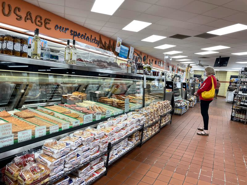 A customer browses meat selections and waits to be serviced at Paulina Meat Market in Chicago