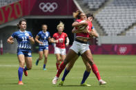 CORRECTS TO BRITAIN NOT BRAZIL - Britain’s Celia Quansah gets lifted by Russian Olympic Committee’s Baizat Khamidova, in their women’s rugby sevens match at the 2020 Summer Olympics, Thursday, July 29, 2021 in Tokyo, Japan. (AP Photo/Shuji Kajiyama)