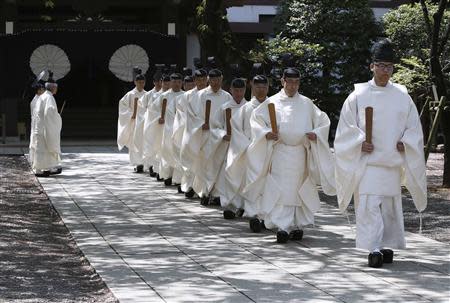 The Yasukuni Shrine's Shinto priests walk during its Annual Spring Festival in Tokyo April 22, 2014. REUTERS/Yuya Shino