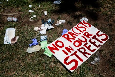 Bloody bandages and protest signs lay on the lawn of the California State Capitol after multiple people were stabbed during a clash between neo-Nazis holding a permitted rally and counter-protestors on Sunday in Sacramento, California, United States, June 26, 2016. REUTERS/Max Whittaker