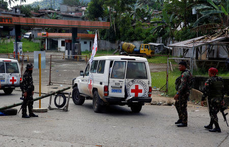 Philippine Red Cross vehicles that evacuated residents in Marawi City, drive past a military checkpoint as fighting rages between government soldiers and the Maute militant group, in southern Philippines May 27, 2017. REUTERS/Erik De Castro