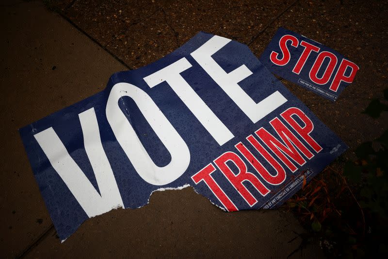 A torn voting sign lies on the pavement, in Philadelphia, Pennsylvania