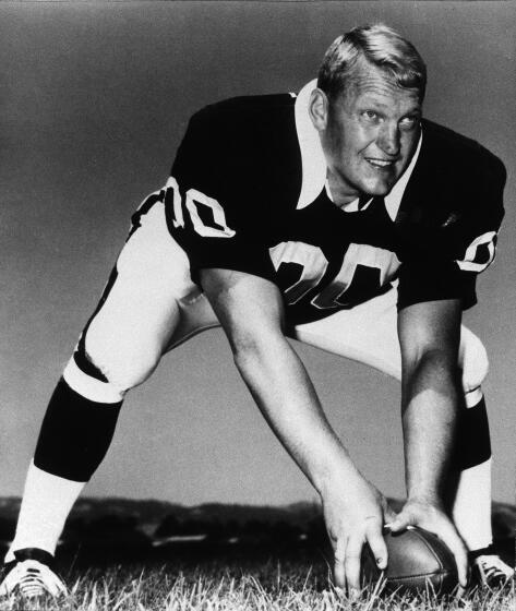 Jim Otto, offensive center of the Oakland Raiders stands in a pose to indicate he's about to snap the football