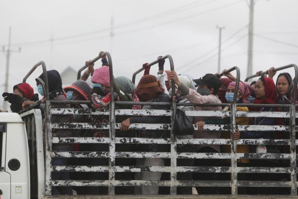 Cambodian garment workers head home after their shift. Interviews with nearly 400 workers in 9 countries reveal an average wage drop of 21% since the start of the pandemic.