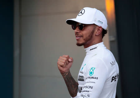 Formula One - F1 - Australian Grand Prix - Melbourne, Australia - 25/03/2017 - Mercedes driver Lewis Hamilton of Britain reacts after setting pole position in qualifying. REUTERS/Jason Reed