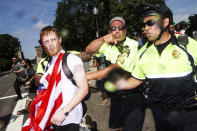 <p>A man on the left with American flag, allegedly a member of white supremacist and a participant of ‘free speech rally’ which held at Boston Common, is being escorted by police out of the place after the rally and being surrounded by hundreds of counter protestors heckling at him in Boston Common. (Photo: Go Nakamura via ZUMA Wire) </p>