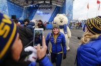 Members of Sweden's Olympic team pose with the Olympic mascot during a welcoming ceremony for the team in the Athletes Village at the Olympic Park ahead of the 2014 Winter Olympic Games in Sochi February 5, 2014. REUTERS/Shamil Zhumatov (RUSSIA - Tags: SPORT OLYMPICS)