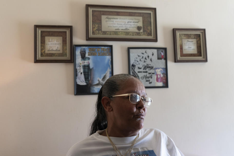 Charlene Roberts stands in her living room as she reflects on the lives her children lost to gun violence Friday, Aug. 4, 2023 in Knoxville, Tenn. Roberts' son, Kevin, was killed in 2021 and her daughter, Jessie, in 2019. Knoxville saw a surge in fatal shootings during the beginning of the pandemic, and community leaders are working on a new effort to reduce gun violence. (AP Photo/George Walker IV)