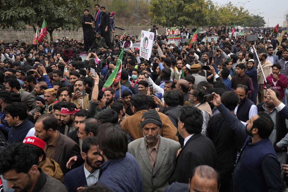 Supporters of former Pakistani Prime Minister Imran Khan move with a vehicle, center, carrying their leader Khan arriving for his court appearance, in Islamabad, Pakistan, Tuesday, Feb. 28, 2023. A Pakistani court approved bail for Khan after he appeared before a judge in Islamabad amid tight security, officials said, months after police filed terrorism charges against the country's popular opposition leader for inciting people to violence. (AP Photo/Anjum Naveed)