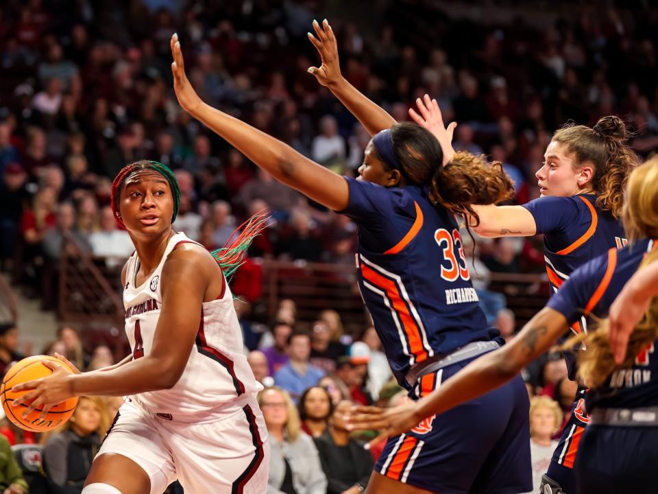 Auburn defenders surround Aliyah Boston.