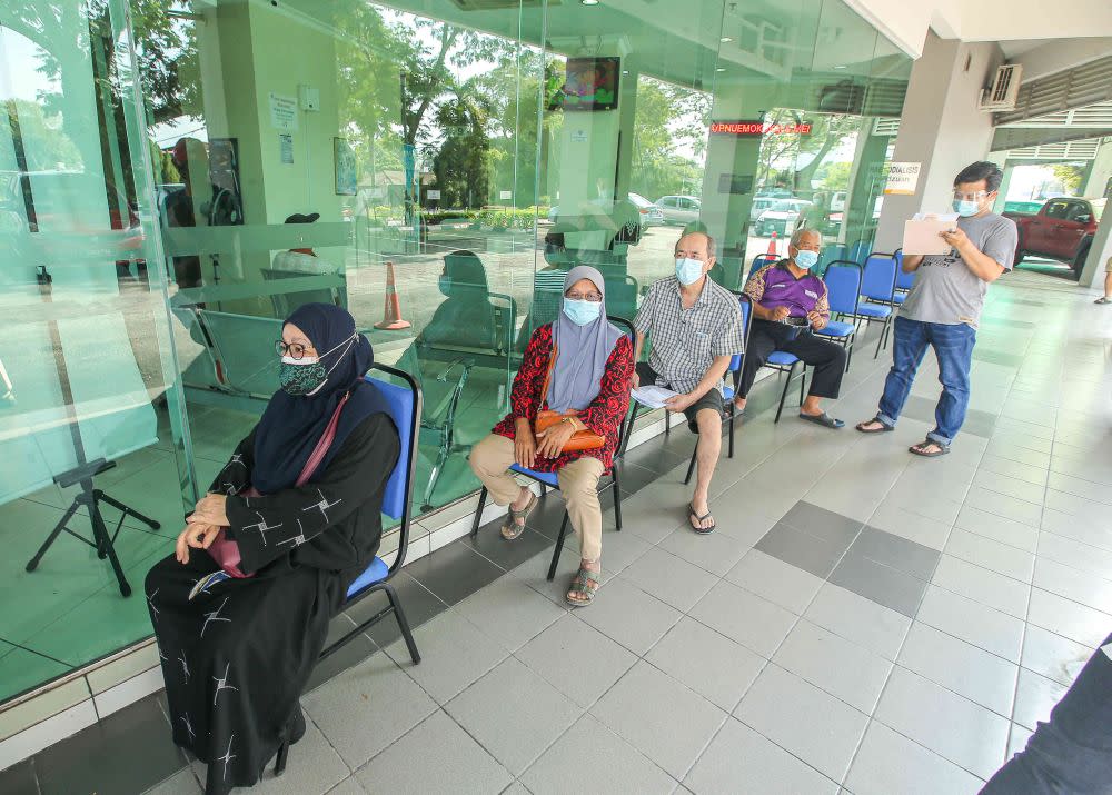 People wait to receive their Covid-19 jab at the Ar-Ridzuan Medical Centre in Ipoh June 7, 2021. — Picture by Farhan Najib