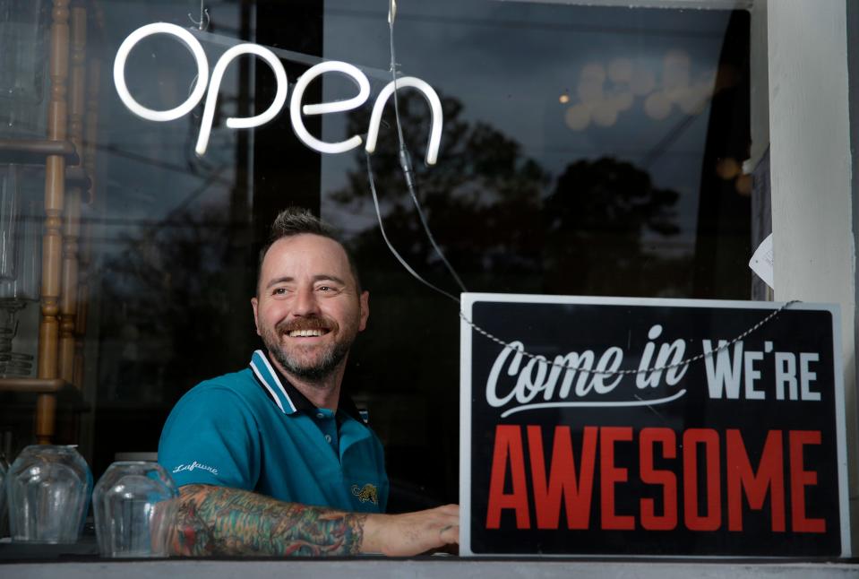 Will Morgan is shown in November in the front window of his Murray Hill business, Vagabond Coffee Co.