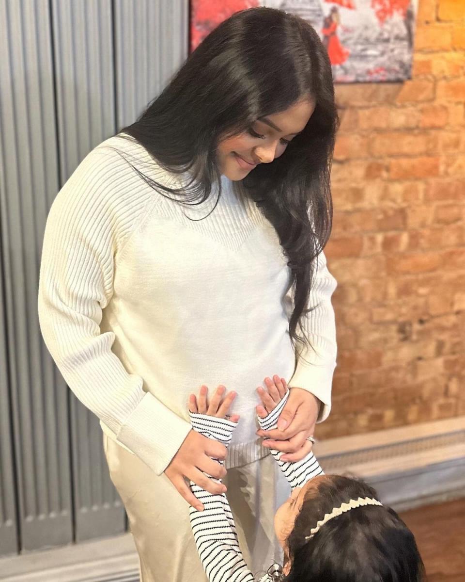 Afshan Azad-Kazi shared a picture of her daughter placing her hands on her growing baby bump (Instagram @Afshan Azad-Kazi)