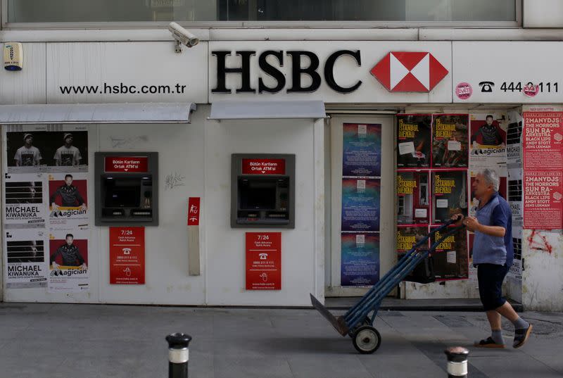 A man walks past by a closed a HSBC bank branch in Istanbul