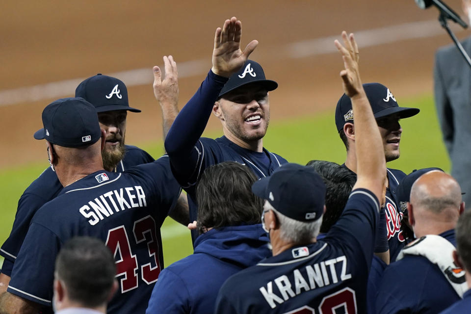 Atlanta Braves' Freddie Freeman, center, celebrates after defeating the Miami Marlins in Game 3 of a baseball National League Division Series, Thursday, Oct. 8, 2020, in Houston. (AP Photo/David J. Phillip)