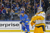 St. Louis Blues' Jordan Kyrou, middle, skates to his bench after scoring a goal against Nashville Predators goaltender Juuse Saros, of Finland, during the second period of an NHL hockey game Saturday, Feb. 15, 2020, in St. Louis. (AP Photo/Billy Hurst)