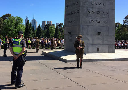 Police officers stand guard as people attend a memorial service at the Shrine of Remembrance to mark the centenary of the Armistice ending World War One, in Melbourne, Australia, November 11, 2018. REUTERS/Sonali Paul