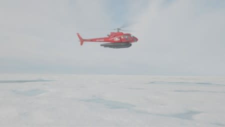 A research helicopter of the U.S.-led Northwest Passage Project flies over the Canadian Arctic during an 18-day icebreaker expedition that took place in July and August 2019