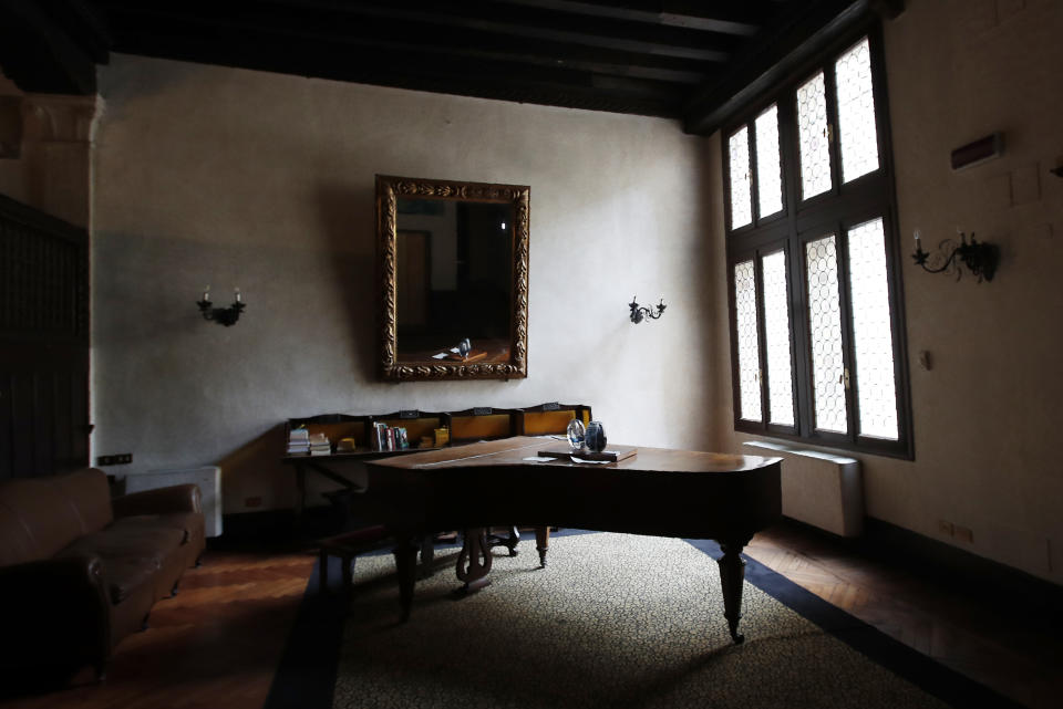 In this picture taken on Wednesday, May 13, 2020 a piano is lit by light from a window of the Saturnia hotel, founded in 1908, in Venice, Italy The hotel is currently closed to the public after lockdown measures to prevent the spread of COVID-19 brought national and International leisure travel to a halt, (AP Photo/Antonio Calanni)