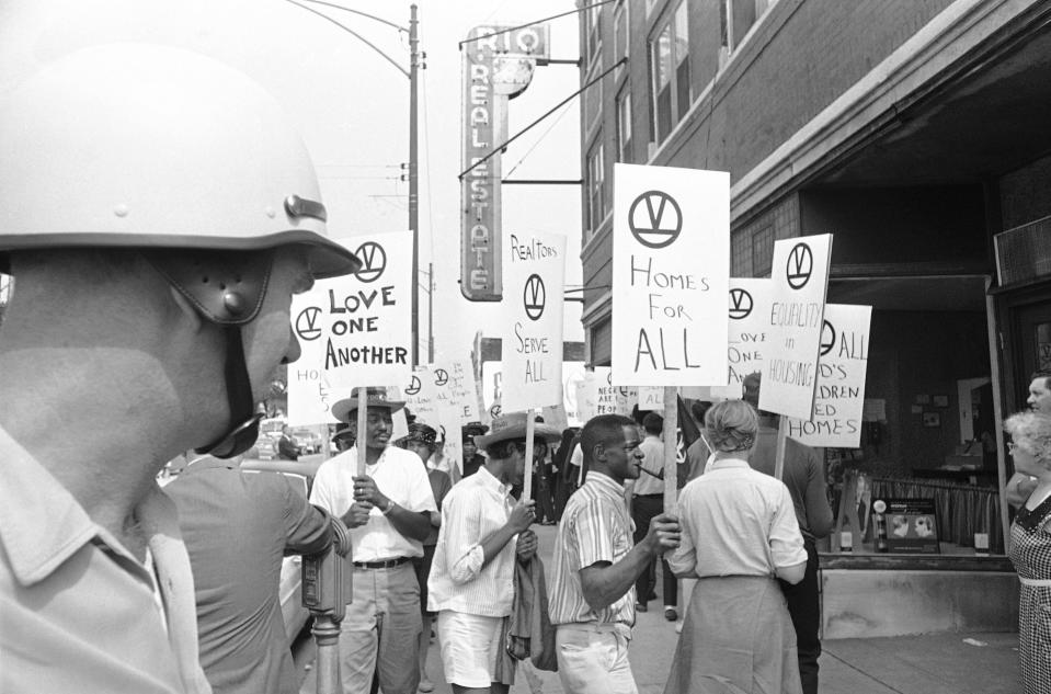 Civil rights marchers parade in front of a real estate office on Chicago’s South Side on Aug. 5, 1966.