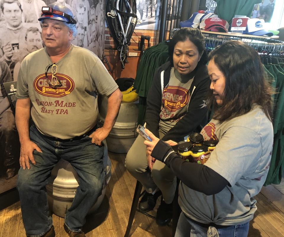 Shawn Shartran, Souk Phonetheva and Kimmy VanHouter are among the 300 union workers at Genesee Brewery who help bring Genny's new Union-Made Hazy IPA to store shelves.