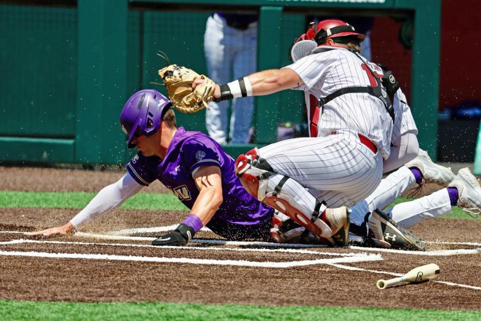 South Carolina’s Cole Messina tags out James Madison’s Brendan O’Donnell at home plate Friday in their NCAA Tournament game at Doak Field at Dail Park in Raleigh, N.C.