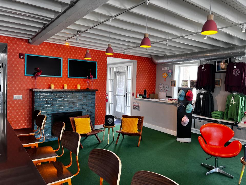 Exit Zero's Filling Station has been revamped for 2023 into an Austin Powers-style bachelor pad, with Astroturf floors and a blue tile fireplace.