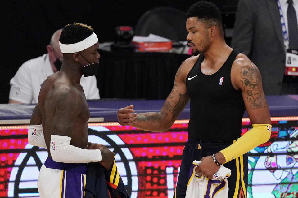 Los Angeles Lakers guard Dennis Schroder, left, and Golden State Warriors forward Kent Bazemore trade jerseys after an NBA basketball game Sunday, Feb. 28, 2021, in Los Angeles. The Lakers won 117-91. (AP Photo/Mark J. Terrill)