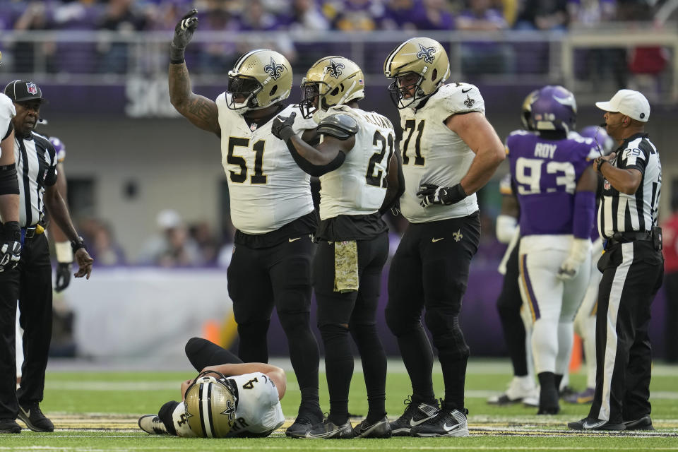 New Orleans Saints center Cesar Ruiz (51) gestures toward the sideline after quarterback Derek Carr, bottom, was injured during the second half of an NFL football game against the Minnesota Vikings Sunday, Nov. 12, 2023, in Minneapolis. (AP Photo/Abbie Parr)