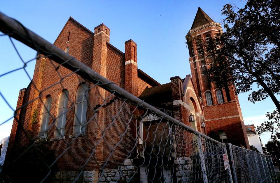 The historic former First United Methodist Church and a former city parking lot in downtown Murfreesboro, on Thursday, July 20, 2023, are surrounded by a chain-link fence. Developers plan a mixed-use redevelopment of the property with 163 apartments, 28 condos, offices, retail spaces, and a 490-space parking garage. The project also will preserve the church sanctuary by using the space as a restaurant or event center.