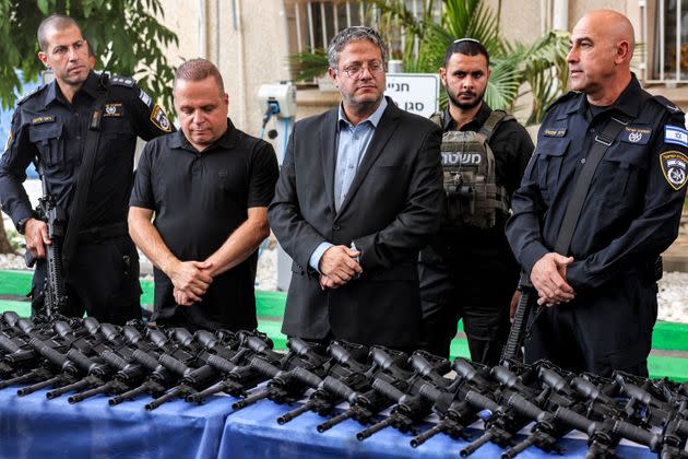 Israel's National Security Minister Itamar Ben-Gvir (center) inspects M5 automatic assault rifles being handed out to volunteers of the new civilian guard unit during the unit's inauguration ceremony in the southern city of Ashkelon on Oct. 27, 2023.