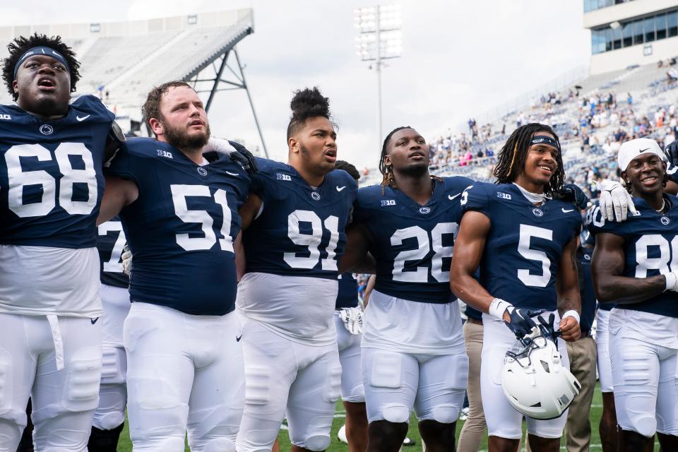 Penn State players, including Anthony Donkoh (68), Dvon Ellies (91), Zane Durant (28), Omari Evans (5) and Cristian Driver (81), sing the alma mater after a 63-7 non-conference win over Delaware at Beaver Stadium Saturday, Sept. 9, 2023, in State College, Pa.