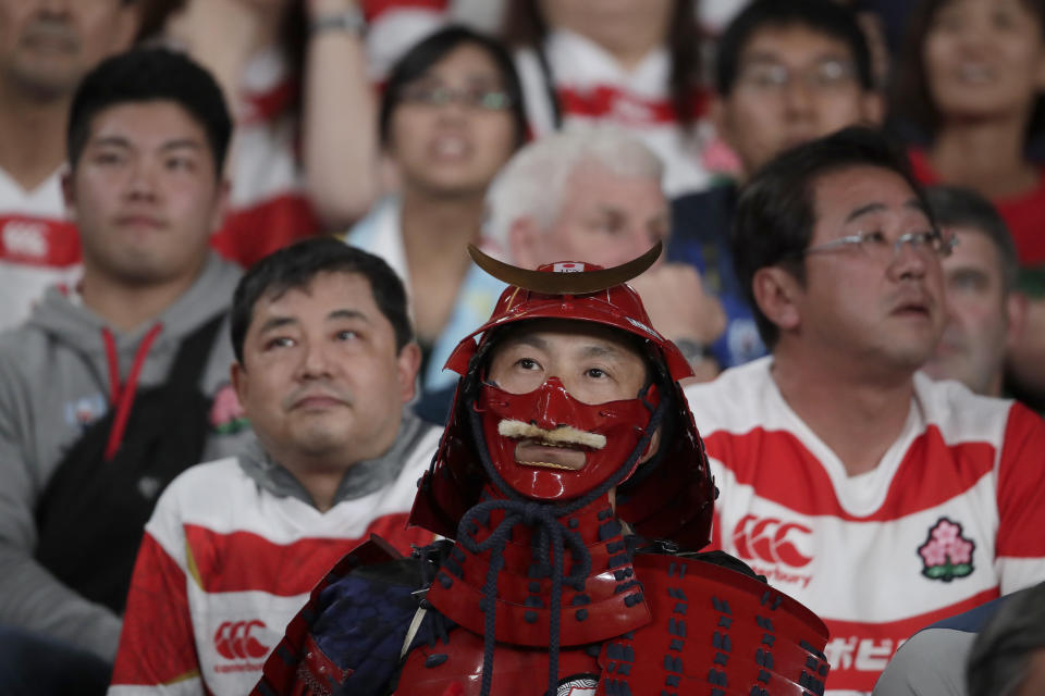 Fans react during the Rugby World Cup quarterfinal match at Tokyo Stadium between Japan and South Africa in Tokyo, Japan, Sunday, Oct. 20, 2019. (AP Photo/Jae C. Hong)