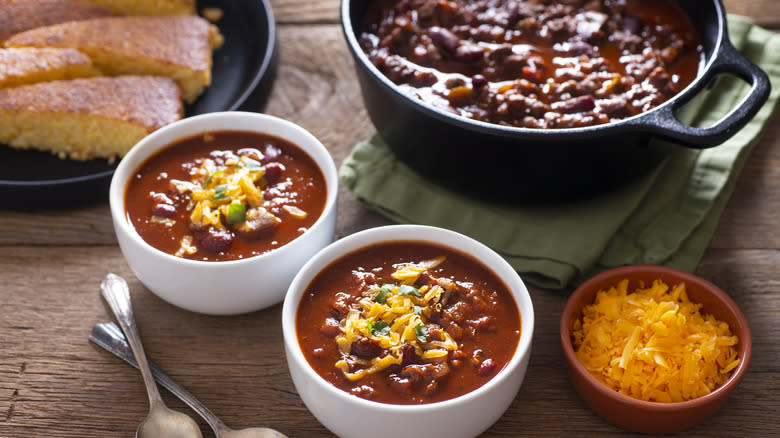 Bowls of chili topped with shredded cheese